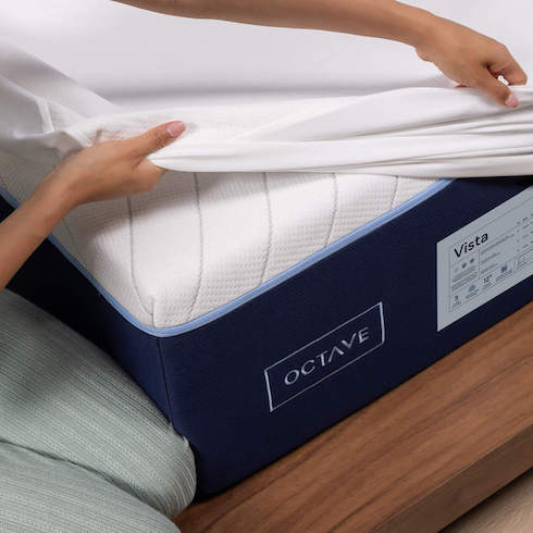 Woman’s hand cover an Octave mattress with a white mattress cover as part of How to Get Rid of Dust From Every Type of Surface at Home for HGTV.ca