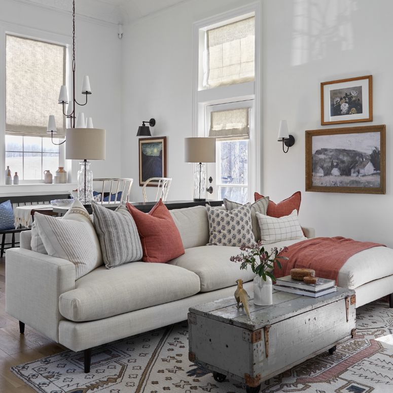 Bright living room with gray couch and mauve accent pillows