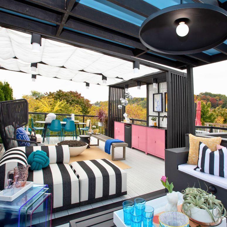 Bright outdoor living area with black and white stiped couch