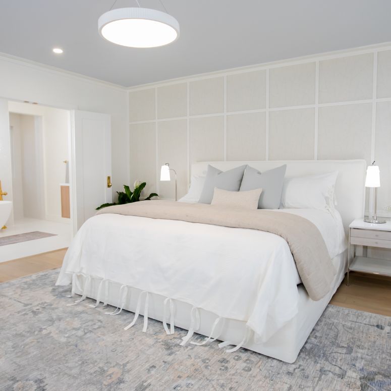 Bright white primary suite bedroom