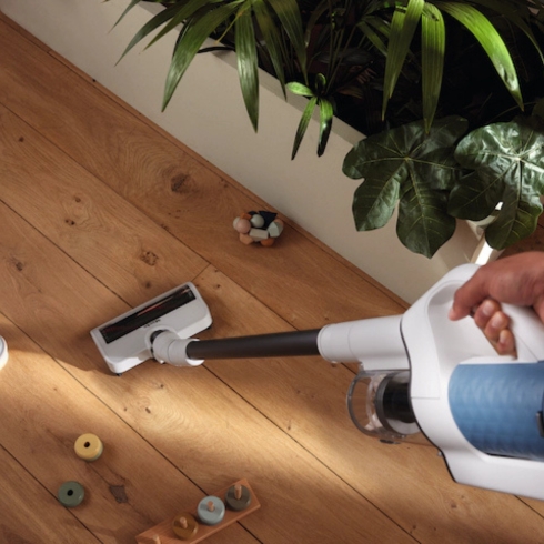 Miele DuoFlex HX1 Cordless Vacuum shown cleaning a wood floor as part of HGTV's Gift Ideas for the Men in Your Life post